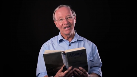 Man holding a book on a black background
